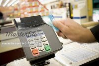 640-02772292em-Person-swiping-debit-card-at-POS-machine.jpg